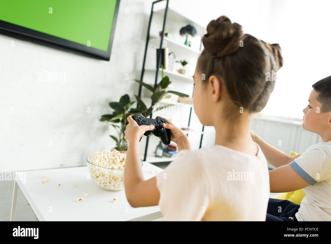 preadolescent children playing video game at home Stock Photo Alamy