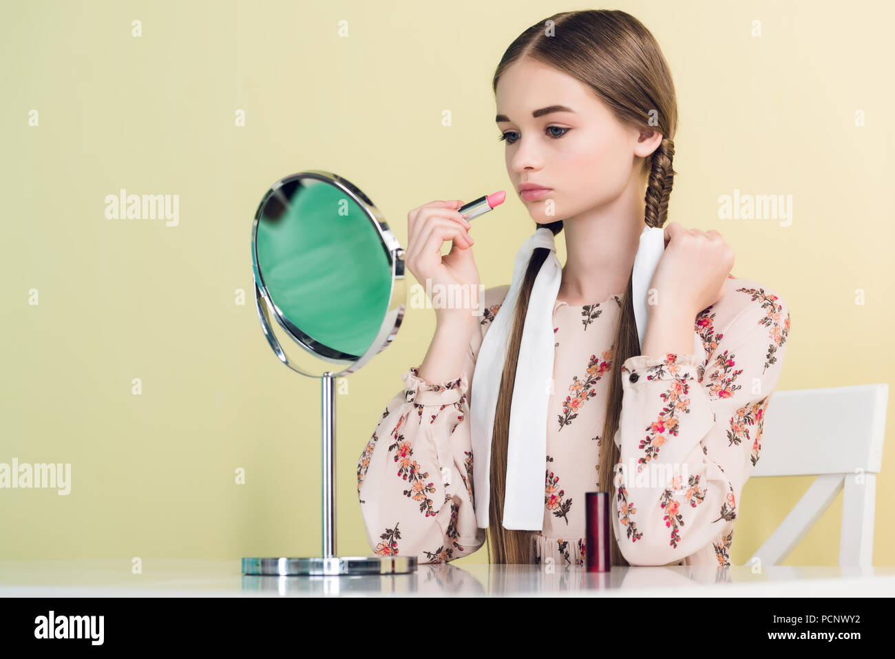 Teen girl applying lipstick hi-res stock photography and images - Alamy