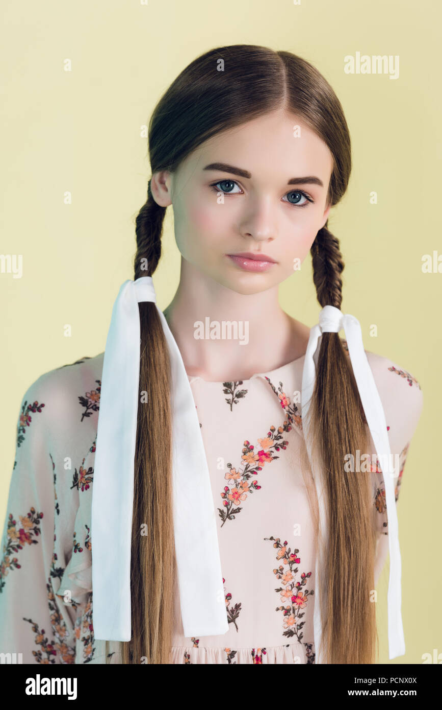 Portrait Of Attractive Teen Girl With Braids Isolated On Yellow