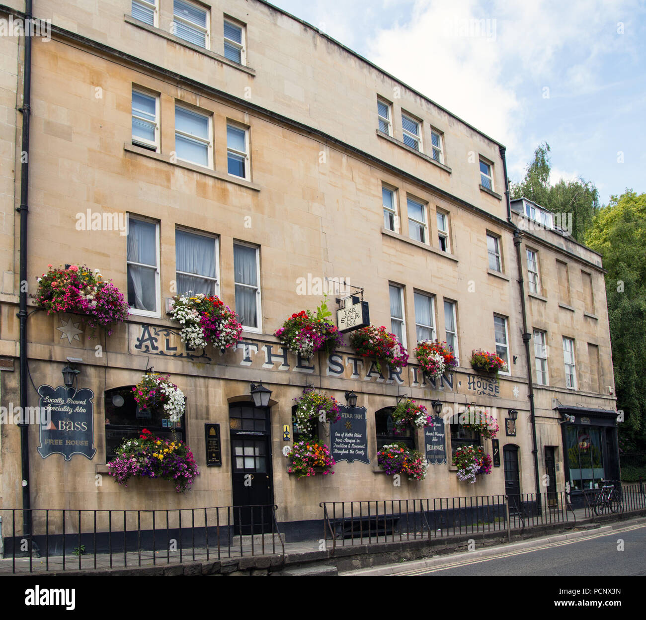 Hanging baskets on the facade of the 18th century Star Inn Ale House, Bath. Stock Photo