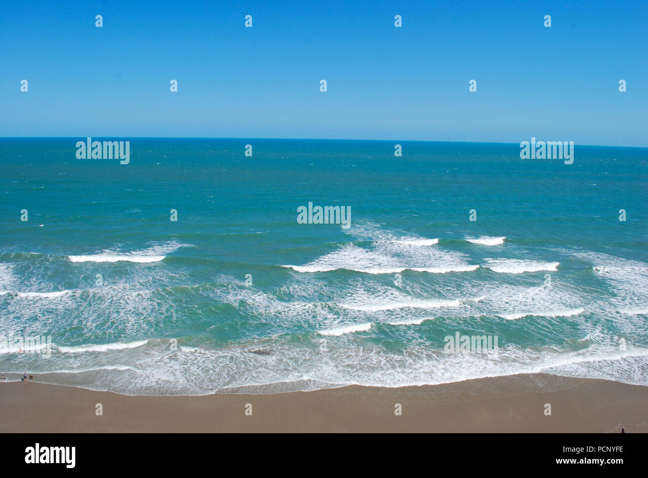 drone view on ocean waves panoramic view with the emerald water of