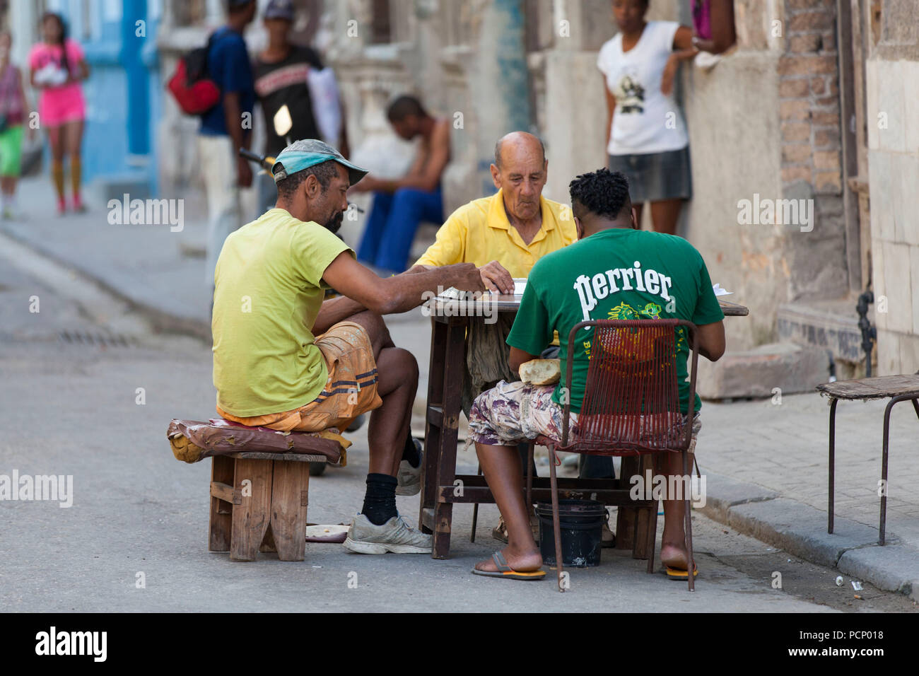 Caribbean, Cuba, Havana, three men playing at dominoes, roadside Stock Photo