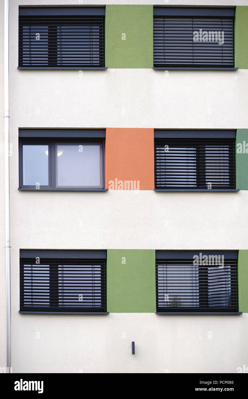 The modern facade of a modern residential building with a shiny metal venetian blind. Stock Photo
