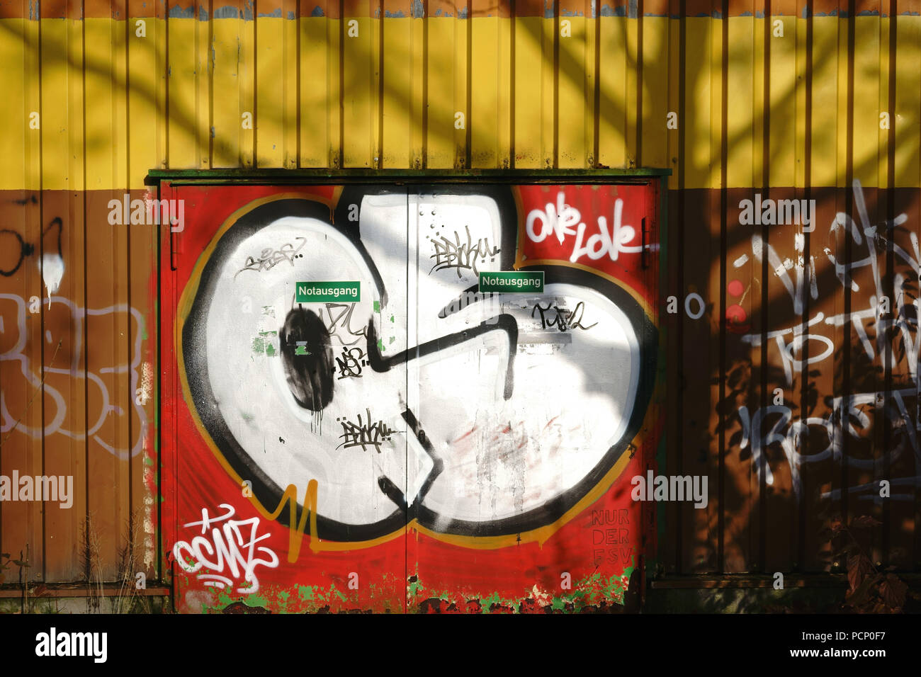 A graffiti painted steel door or rather a fireproof door and emergency exit. Stock Photo