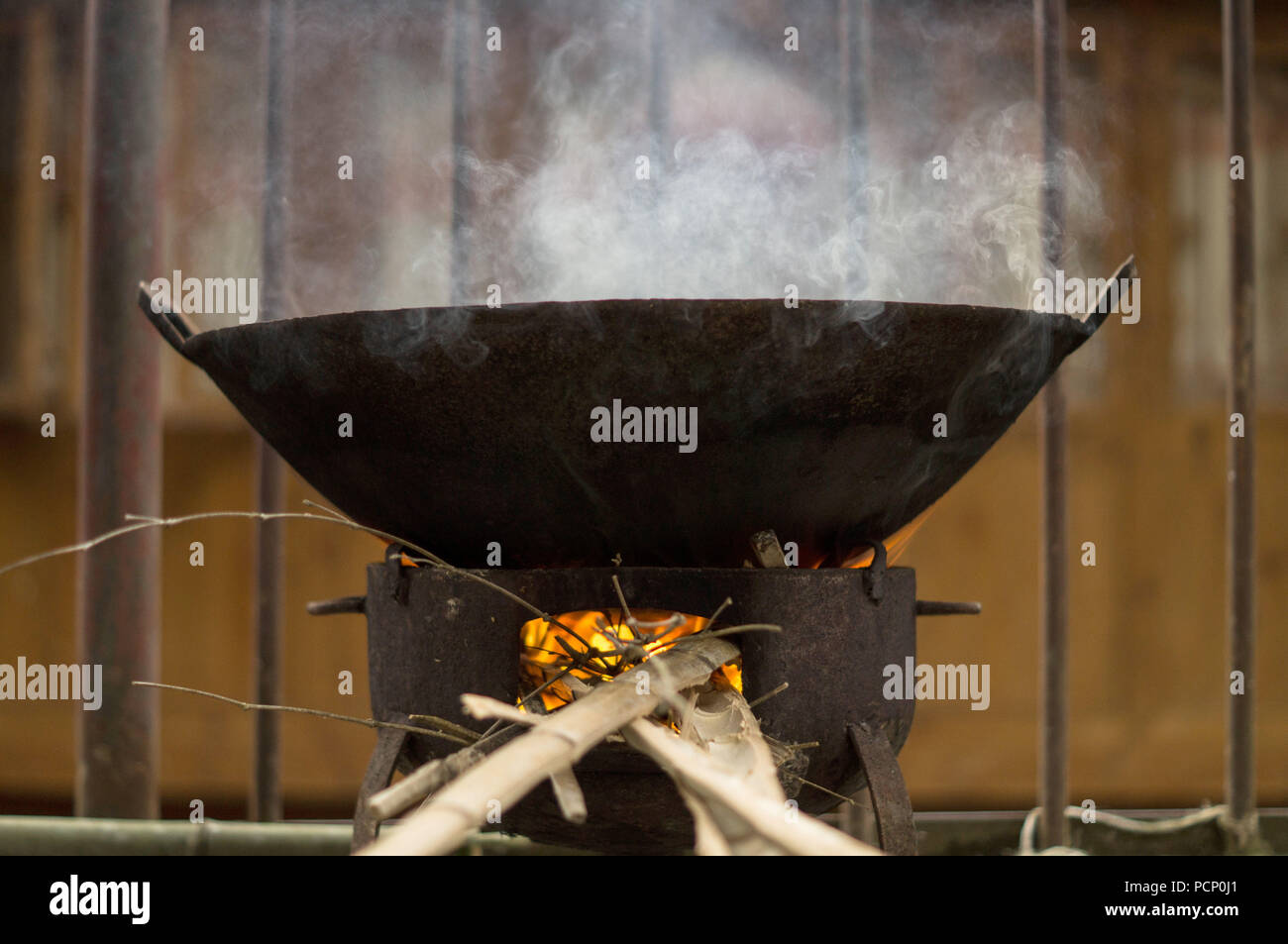A big, traditional wok on an open fire Stock Photo