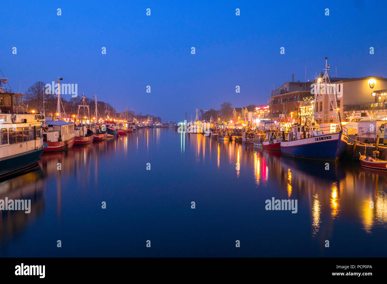 Old current of water in Warnemünde at the blue hour Stock Photo