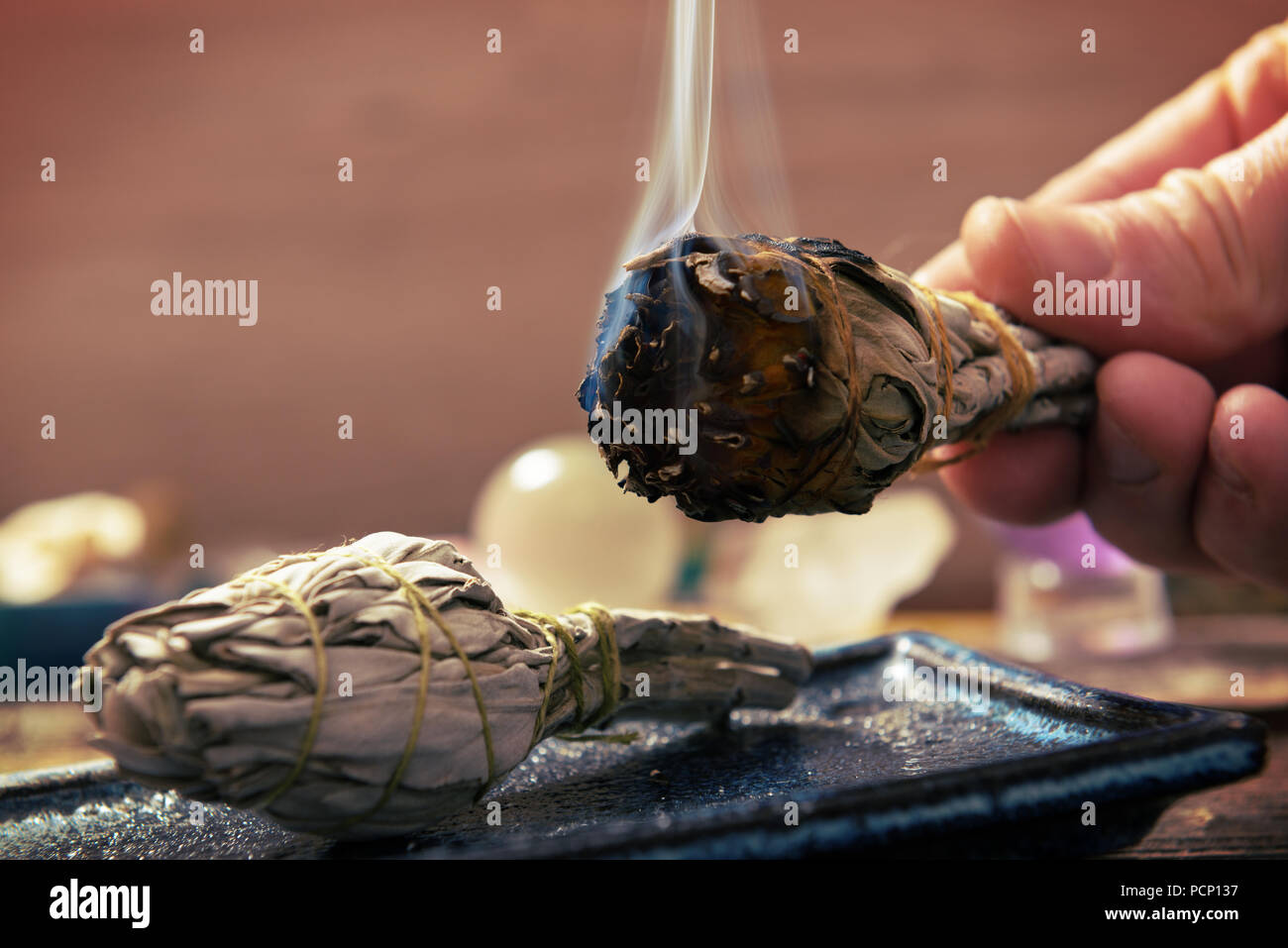 Man's hand with burning natural white sage incense Stock Photo Alamy