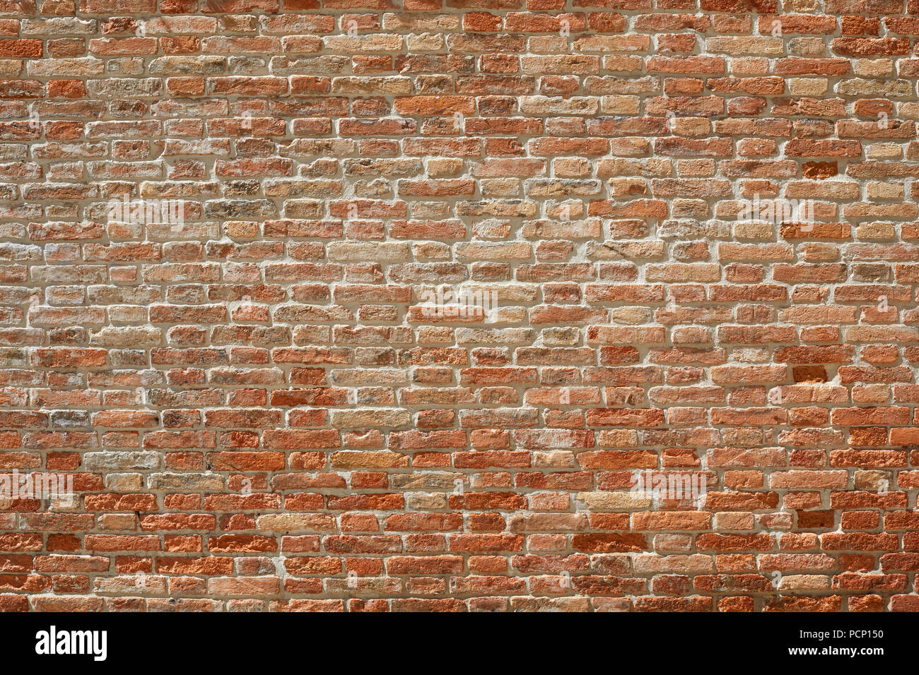 Old red brick wall texture background in sunlight with shadows Stock Photo
