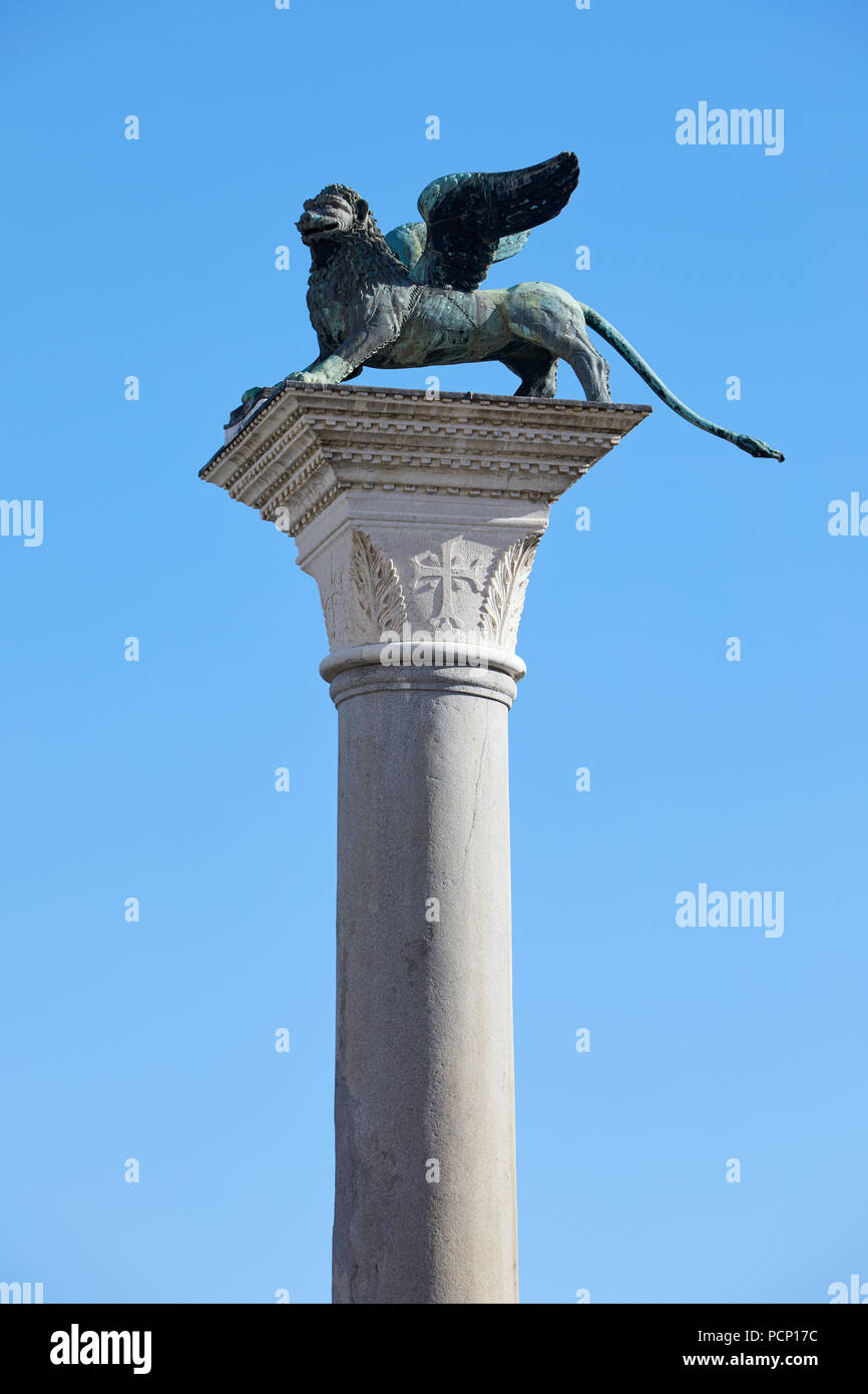 San Marco winged Lion statue on column, symbol of Venice in a sunny day, blue sky in Italy Stock Photo