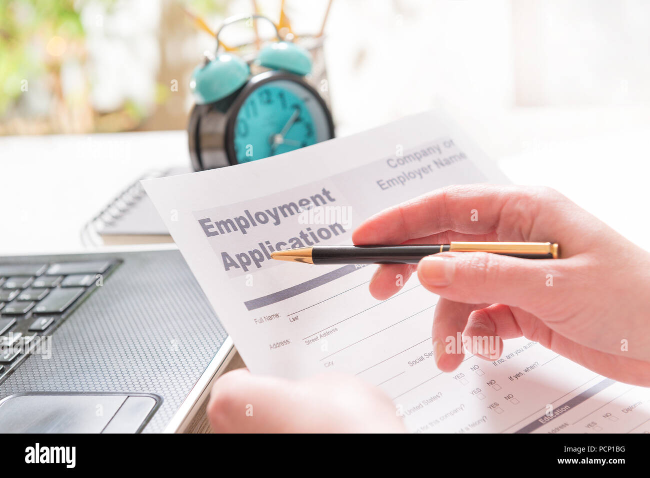 Blank employment application form in hands on a desk Stock Photo Alamy