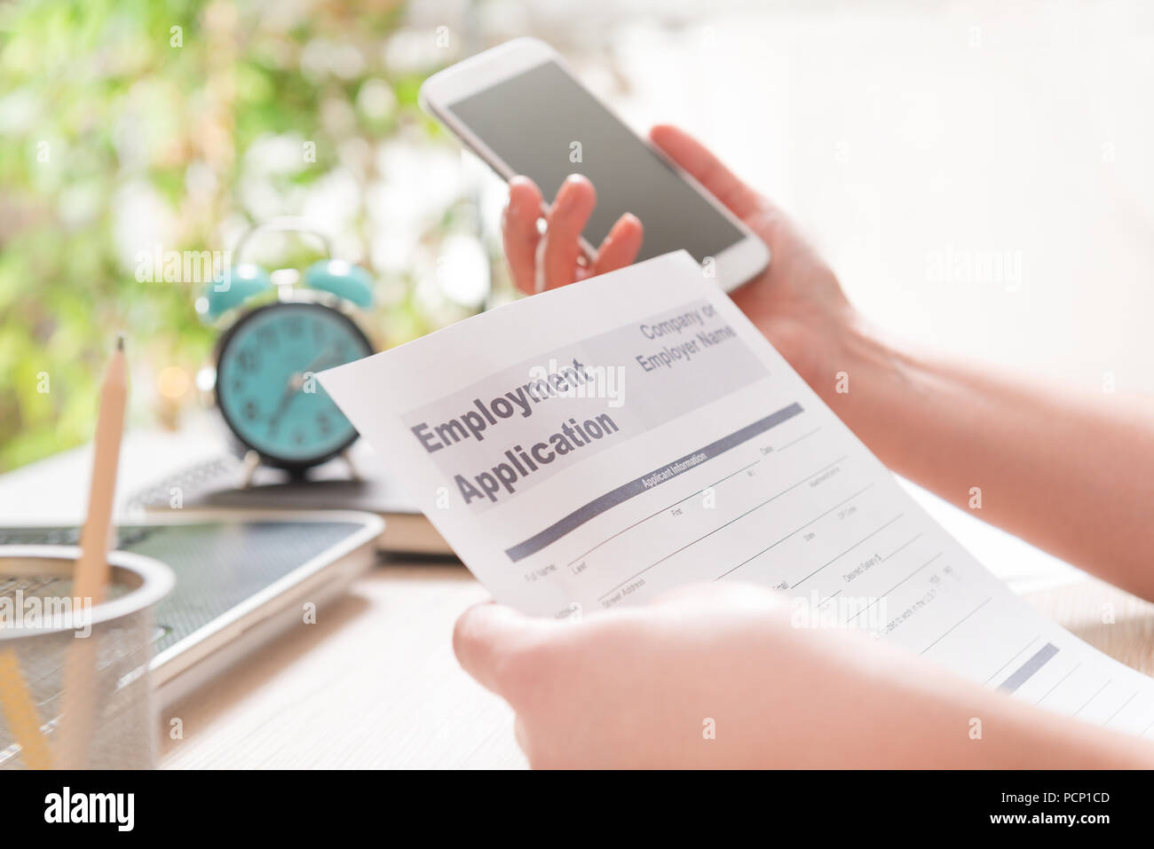Blank employment application form in hands on a desk Stock Photo Alamy