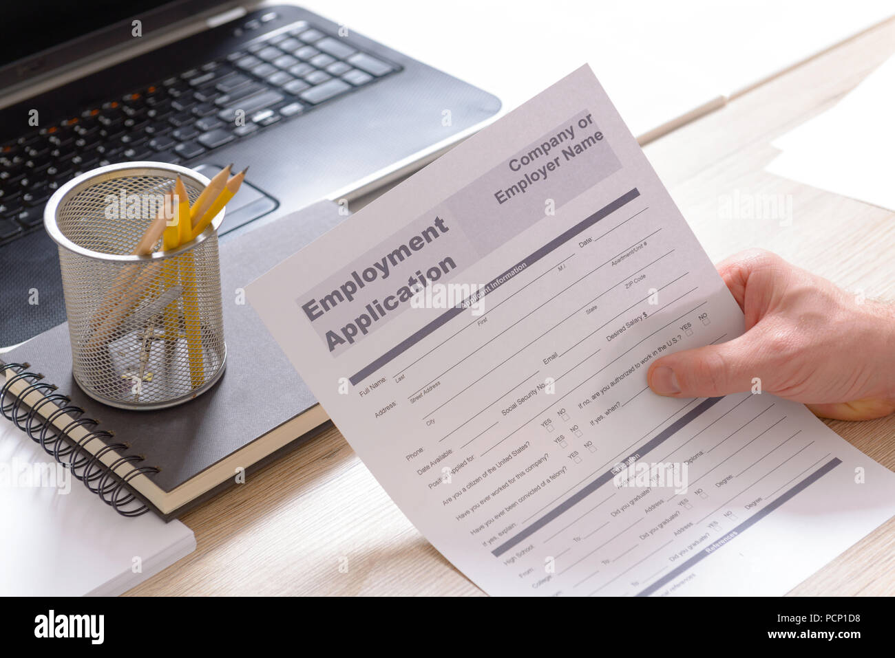 Blank employment application form in hands on a desk Stock Photo Alamy