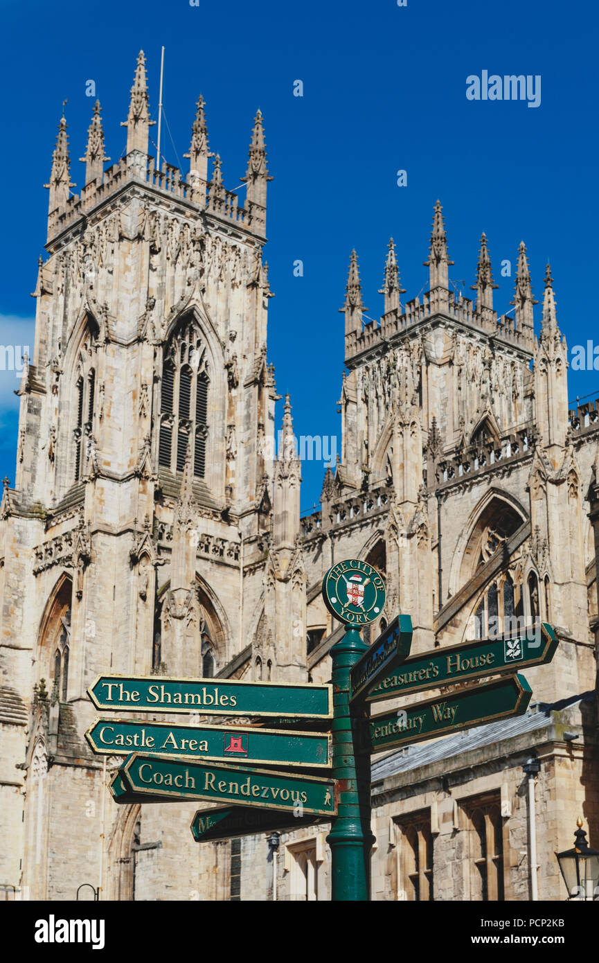 Direction signpost in front of York Minster, the historic cathedral built in English gothic architectural style in the City of York in England, UK Stock Photo