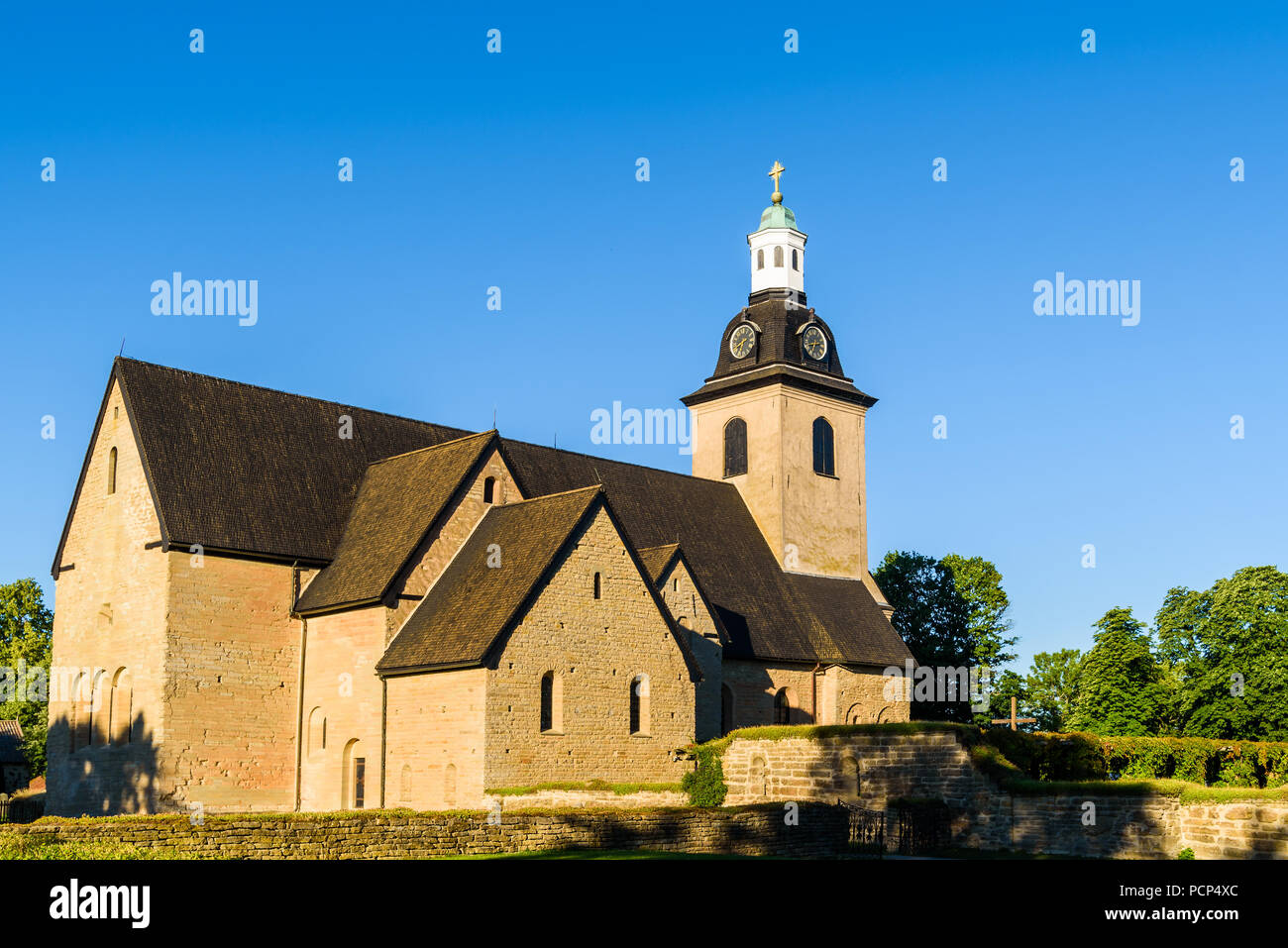 Vreta abbey church in Sweden, on a sunny morning. The oldest parts of the building is from around year 1110. Stock Photo
