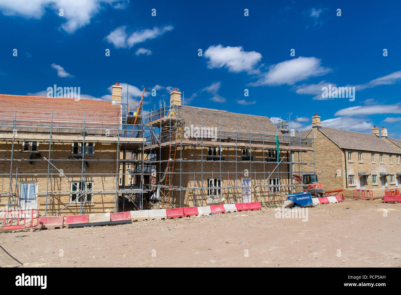 Houses being built on a green field site near Broadway in the Cotswolds, UK. Stock Photo
