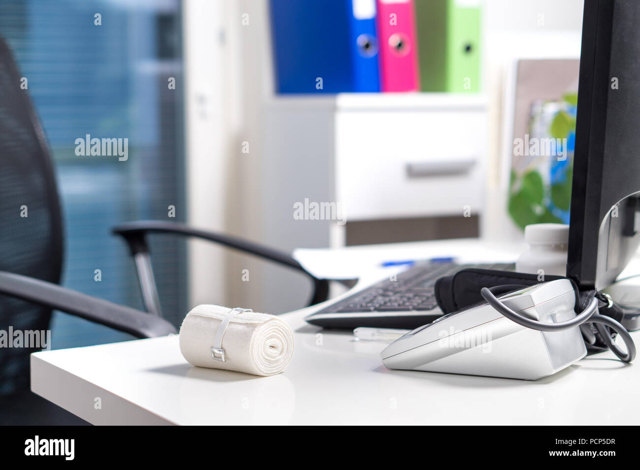 Doctor table, desk and workstation. Empty office in hospital, emergency room or health care center. Medical equipment and instruments. Stock Photo