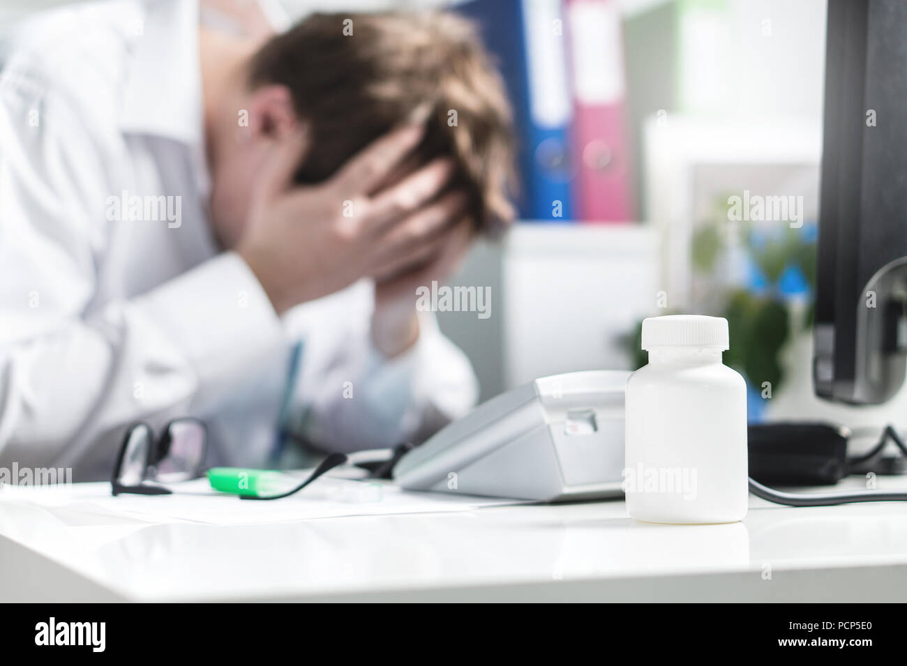 Sad, stressed, upset and unhappy doctor cover face in hospital office. Depression, burnout stress and pressure from too much work. Stock Photo