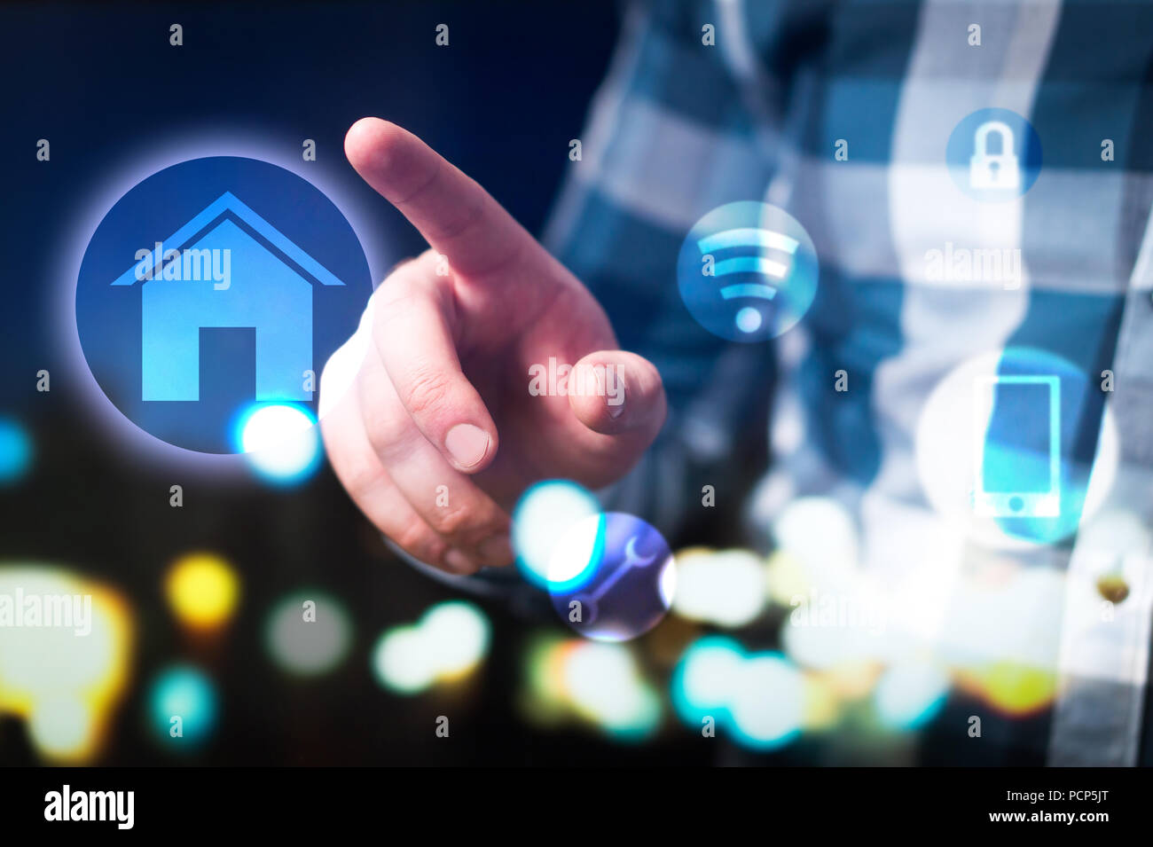Smart home and internet of things (IOT) concept. Man using modern house security, connection and control system. Abstract interface. Stock Photo