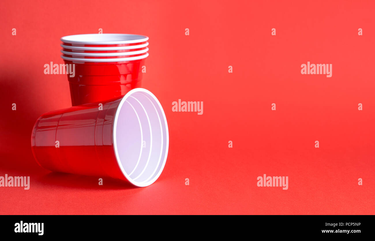 Red party cup background template. Alcohol containers with negative copy space. Stock Photo