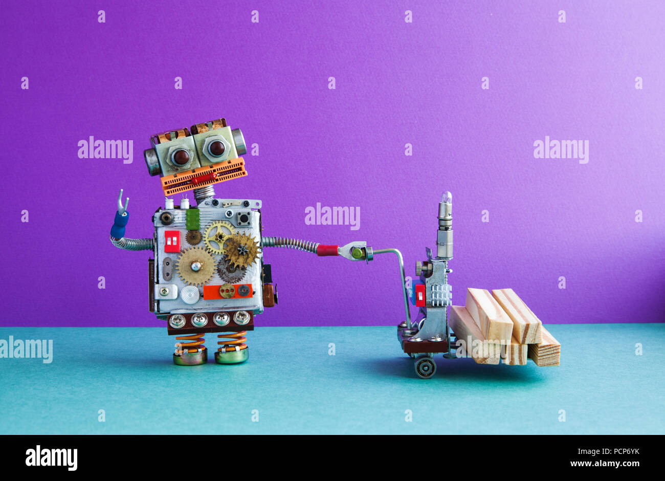 Robot loader moving powered pallet jack with wooden blocks. Forklift