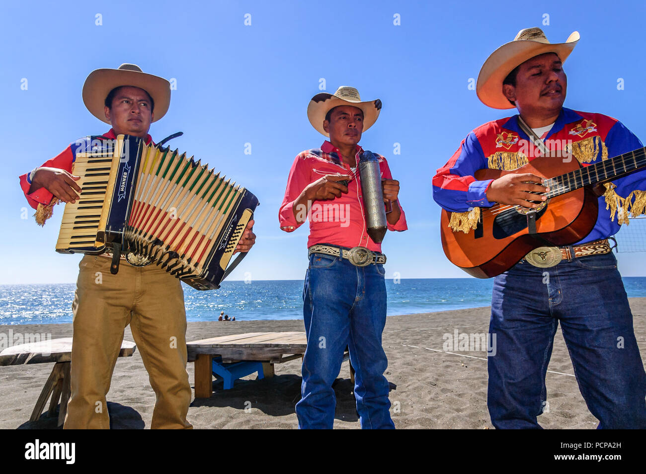 Monterrico, Santa Rosa, Guatemala - February 1, 2015: Mariachi musicians perform for beach goers at Monterrico beach in Santa Rosa department. Stock Photo