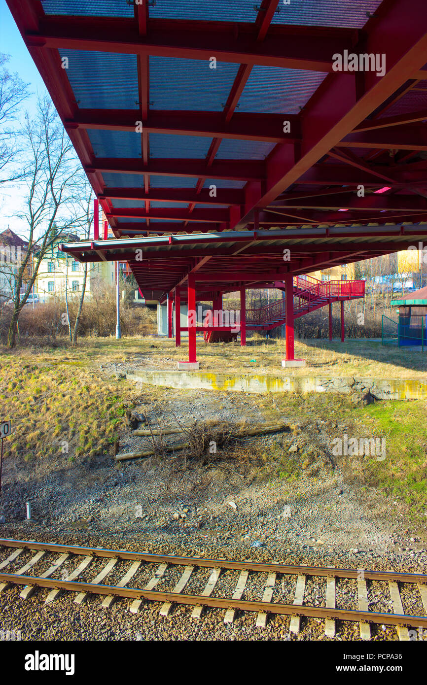 View from the bottom of the metallic red bridge over the railway in Frydek Mistek in the Czech Republic. Stock Photo