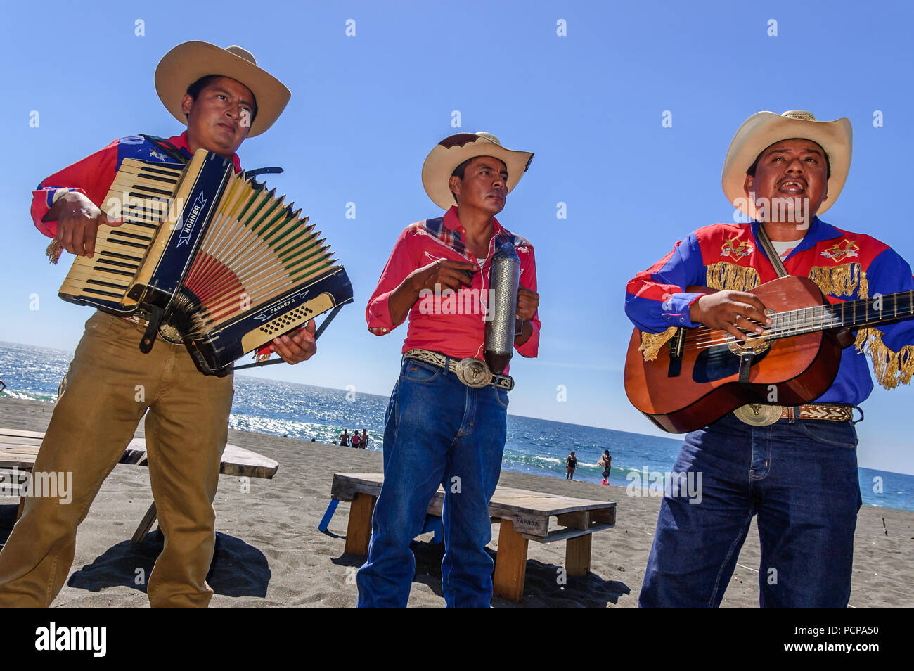 Monterrico, Santa Rosa, Guatemala - February 1, 2015: Mariachi musicians perform for beach goers at Monterrico beach in Santa Rosa department. Stock Photo