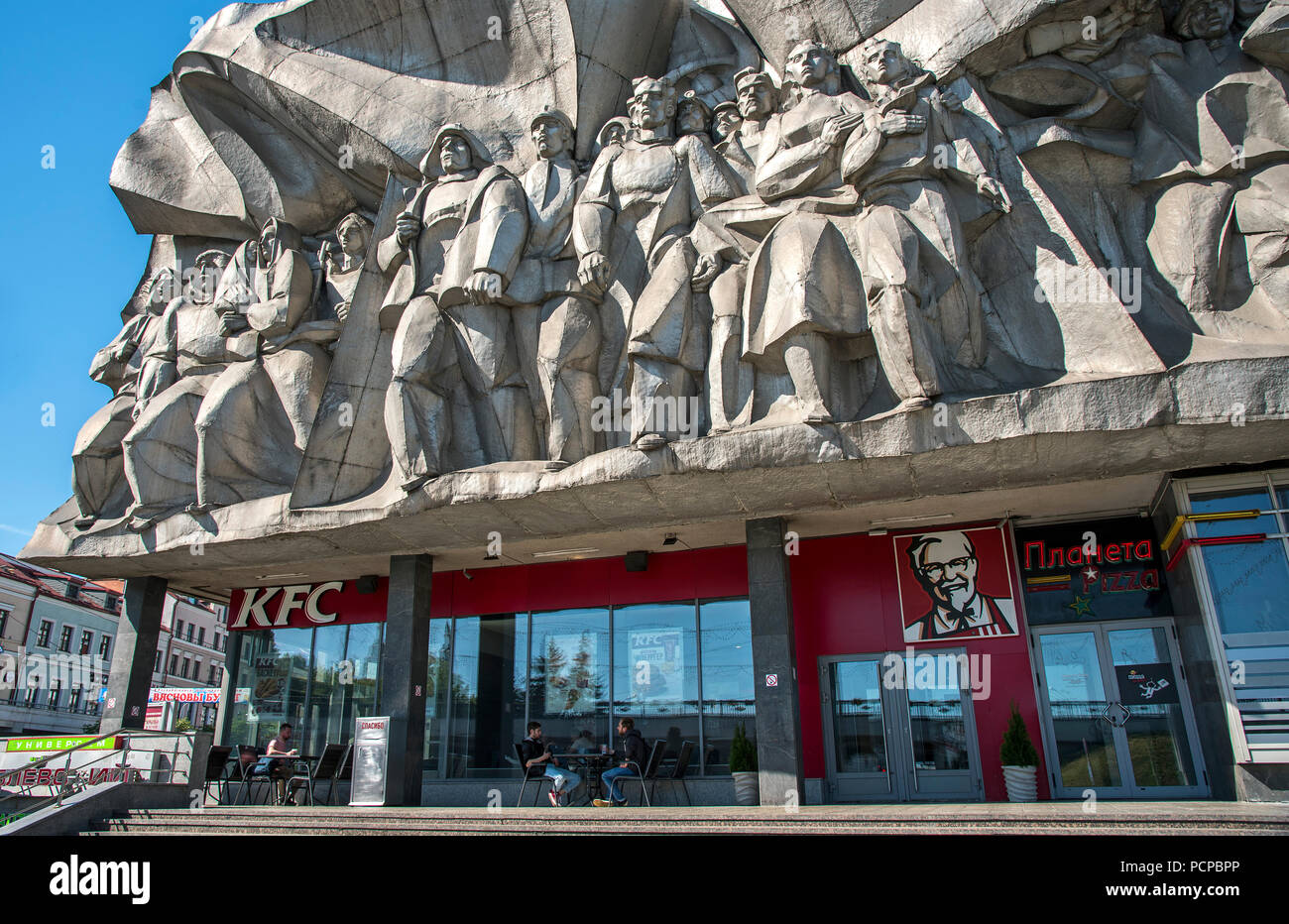 KFC with Soviet Socialist Realism sculpture above. Minsk, Belarus Stock Photo