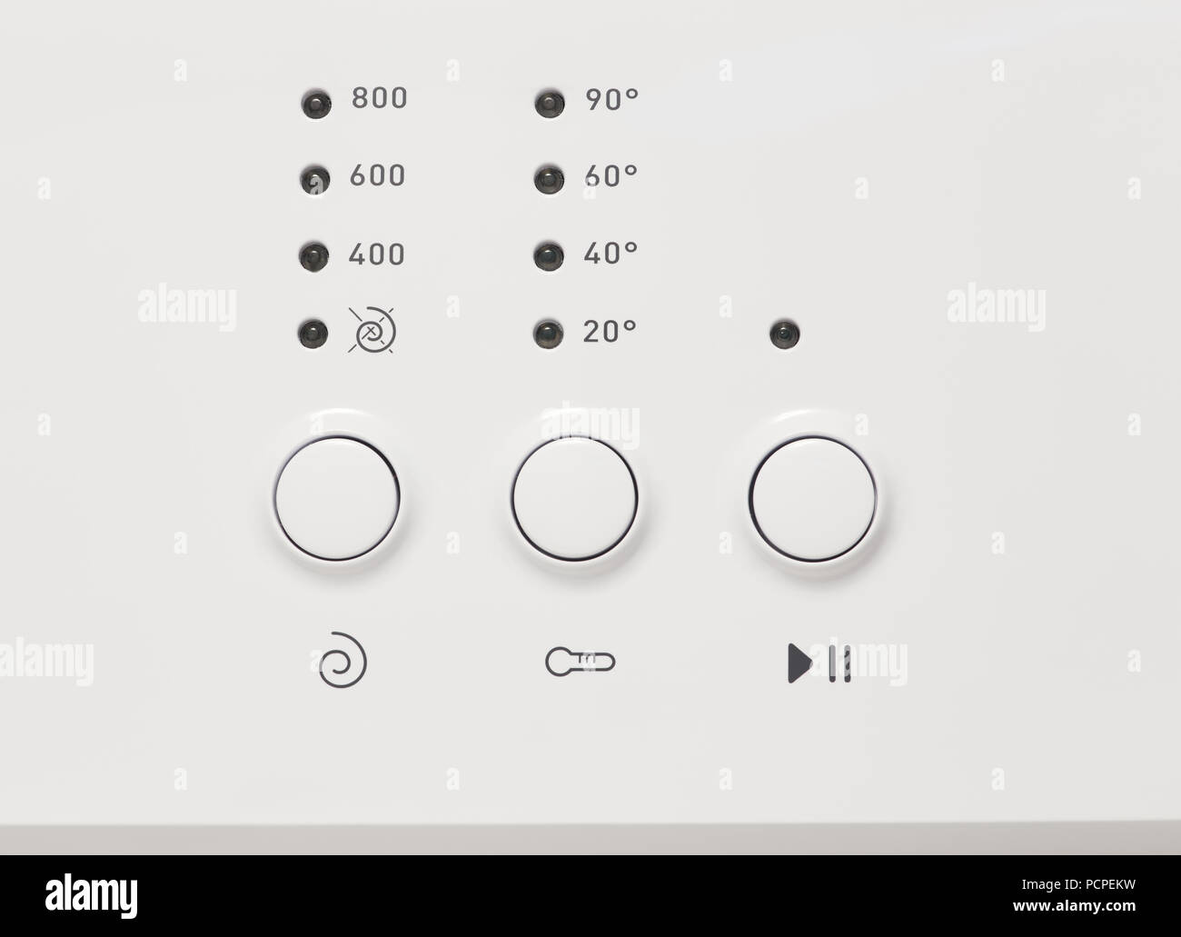 Close-up shot of buttons and lights located on control panel of modern washing machine Stock Photo