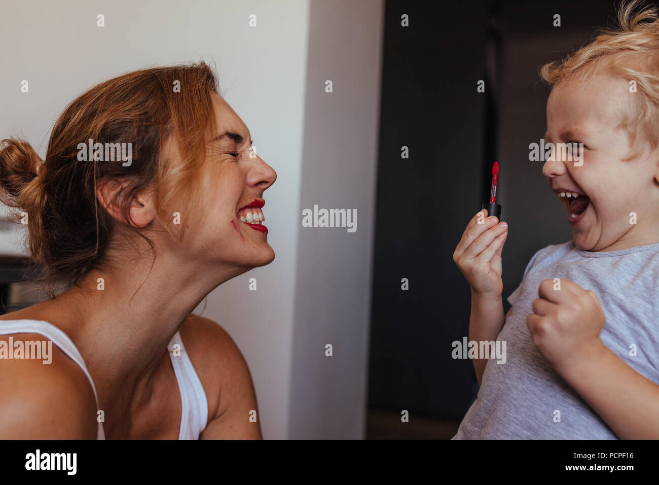 Young boy putting on lipstick hires stock photography and images Alamy