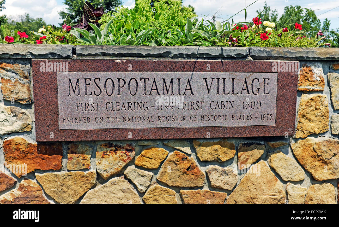 Marble and stone decorative wall announcing 'Mesopotamia Village', the primarily Amish enclave in Mesopotamia, Ohio. Stock Photo