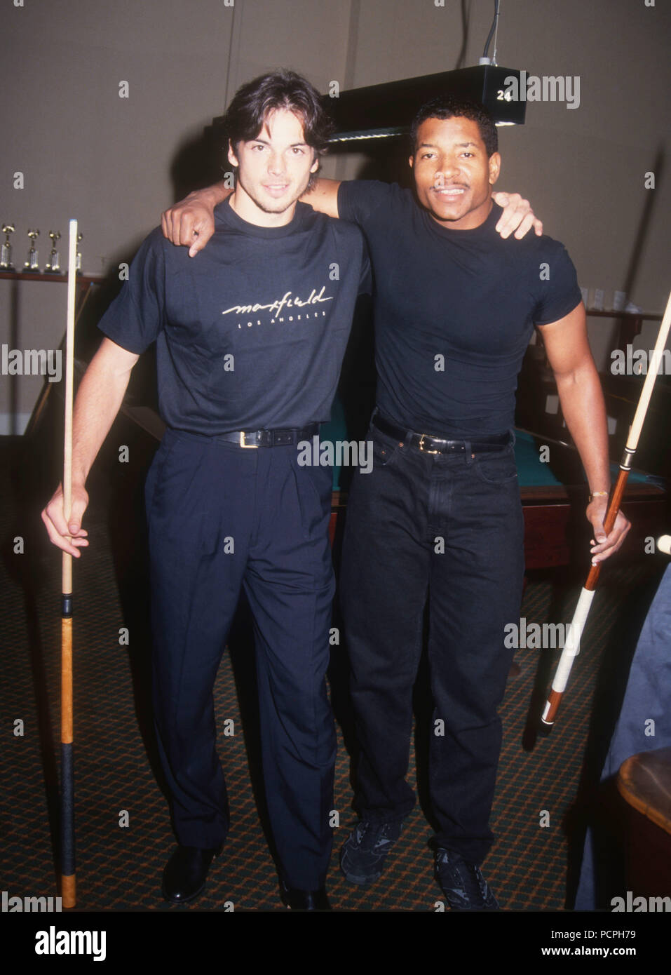 HOLLYWOOD, CA - MAY 30: Actor Jason Gedrick and Rapper Young MC attend the First Annual Celebrity Pool Tournament to Benefit AIDS Project Los Angeles (APLA) on May 30, 1992 at the Hollywood Athletic Club in Hollywood, California. Photo by Barry King/Alamy Stock Photo Stock Photo