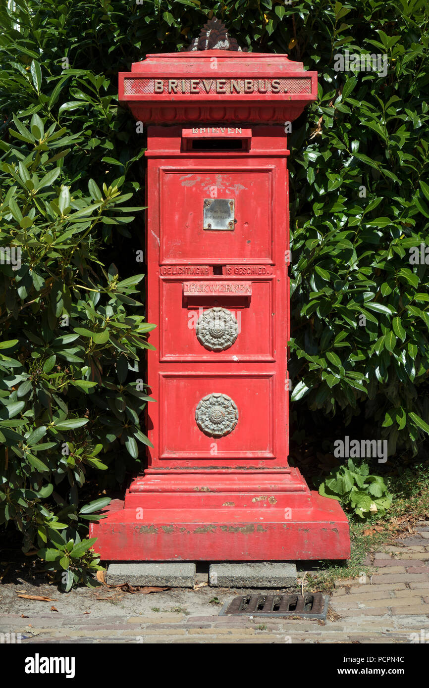 Classic red Dutch letterbox standing outside as decoration Stock Photo