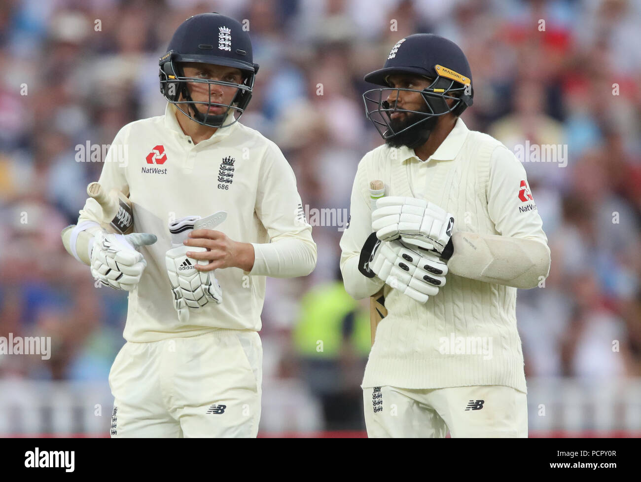 England batsman Sam Curran (left) and Adil Rashid walk off the pitch for bad light during day three of the Specsavers First Test match at Edgbaston, Birmingham. Stock Photo