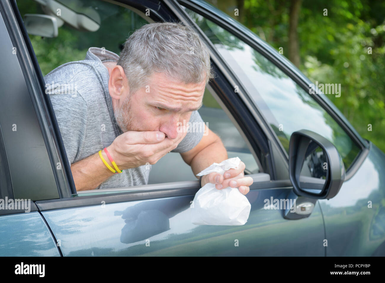 Man vomiting in bag hires stock photography and images Alamy