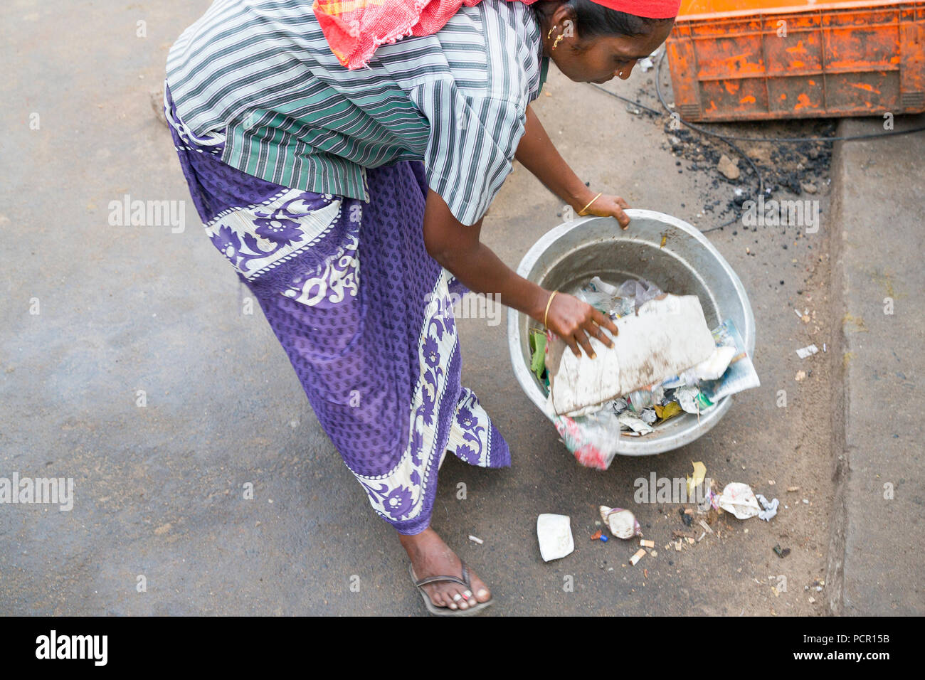 Indian woman take garbage in the street Stock Photo