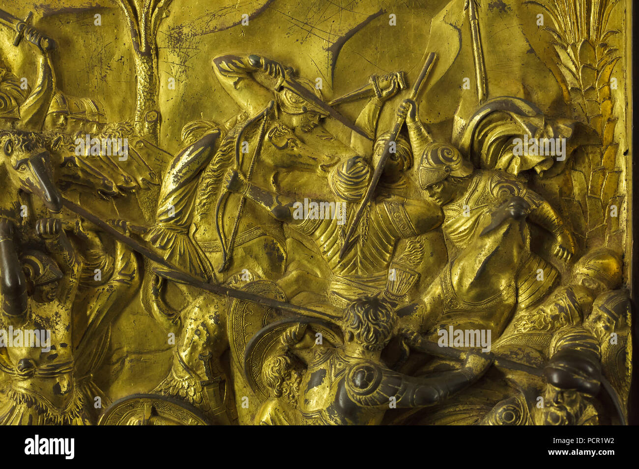 Battles between the Israelites and the Philistines depicted in the gilded bronze panel from the Gates of Paradise (Porta del Paradiso) designed by Italian Early Renaissance sculptor Lorenzo Ghiberti for the Florence Baptistery (Battistero di San Giovanni), now on display in the Museo dell'Opera del Duomo (Museum of the Works of the Florence Cathedral) in Florence, Tuscany, Italy. Stock Photo