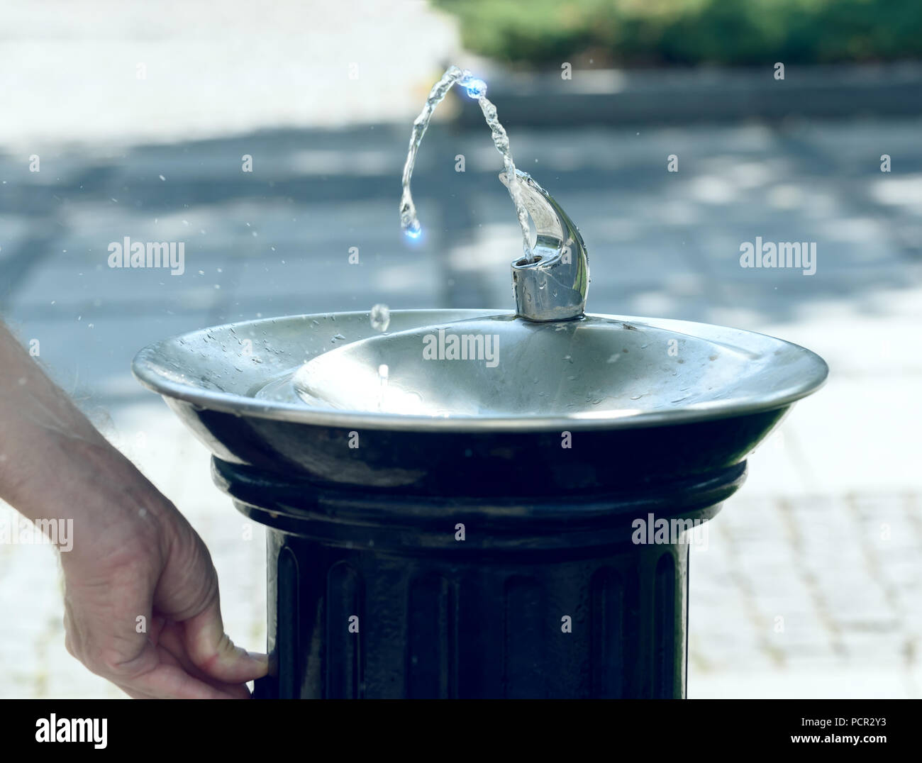Drinking water flowing from a fountain in a city Stock Photo Alamy