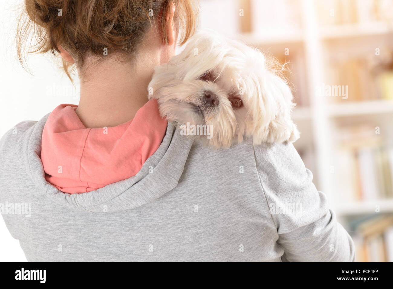 Woman holding puppy on shoulder hi-res stock photography and images - Alamy