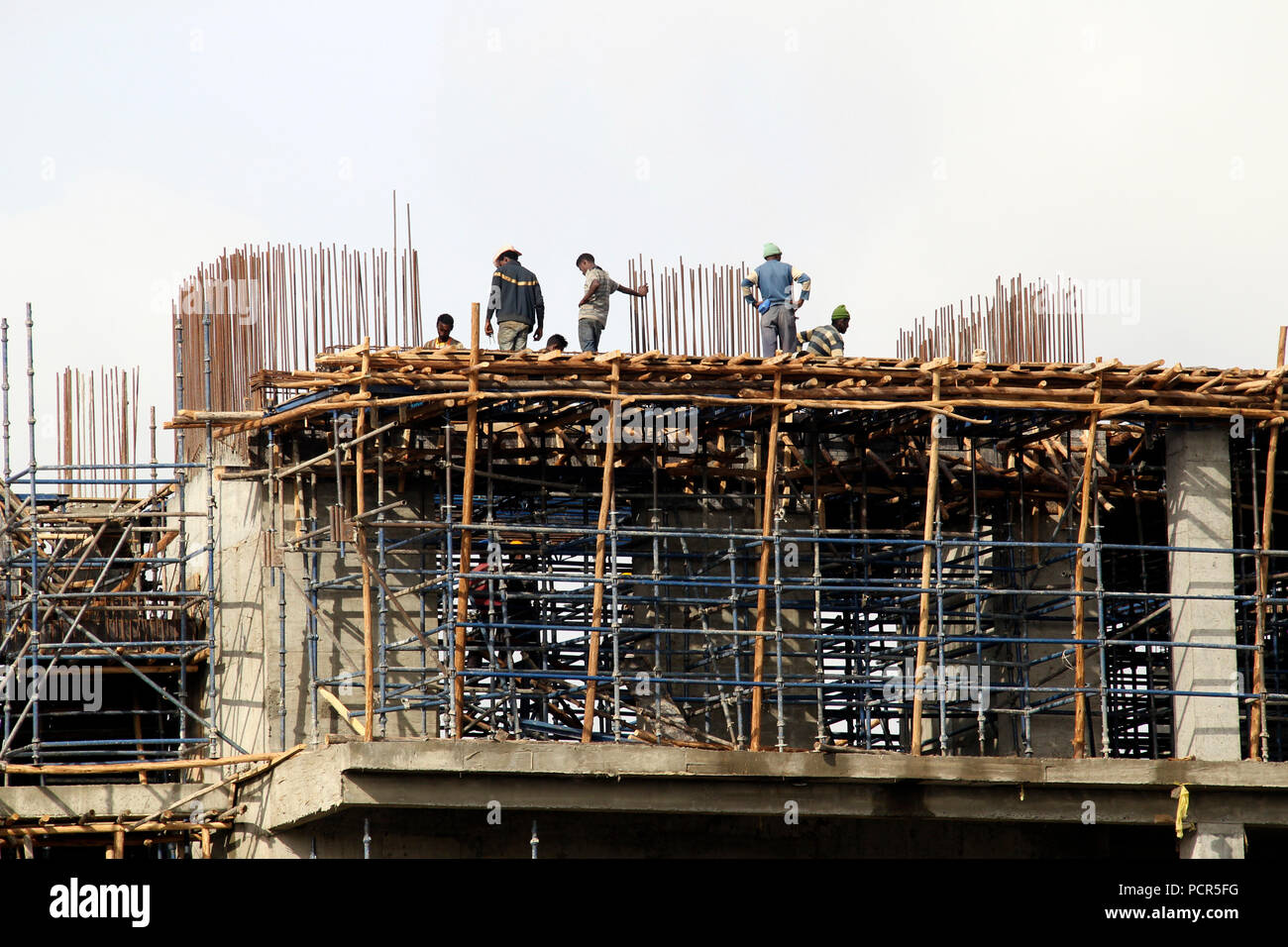 Wooden scaffolding on building shell, construction work, Addis Ababa, Ethiopia Stock Photo
