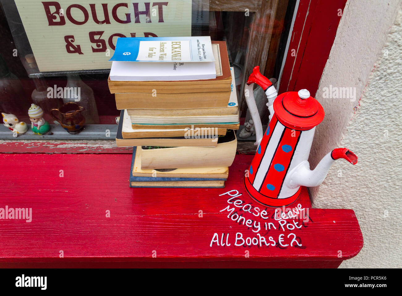 second hand softback books for sale on a window ledge. Stock Photo