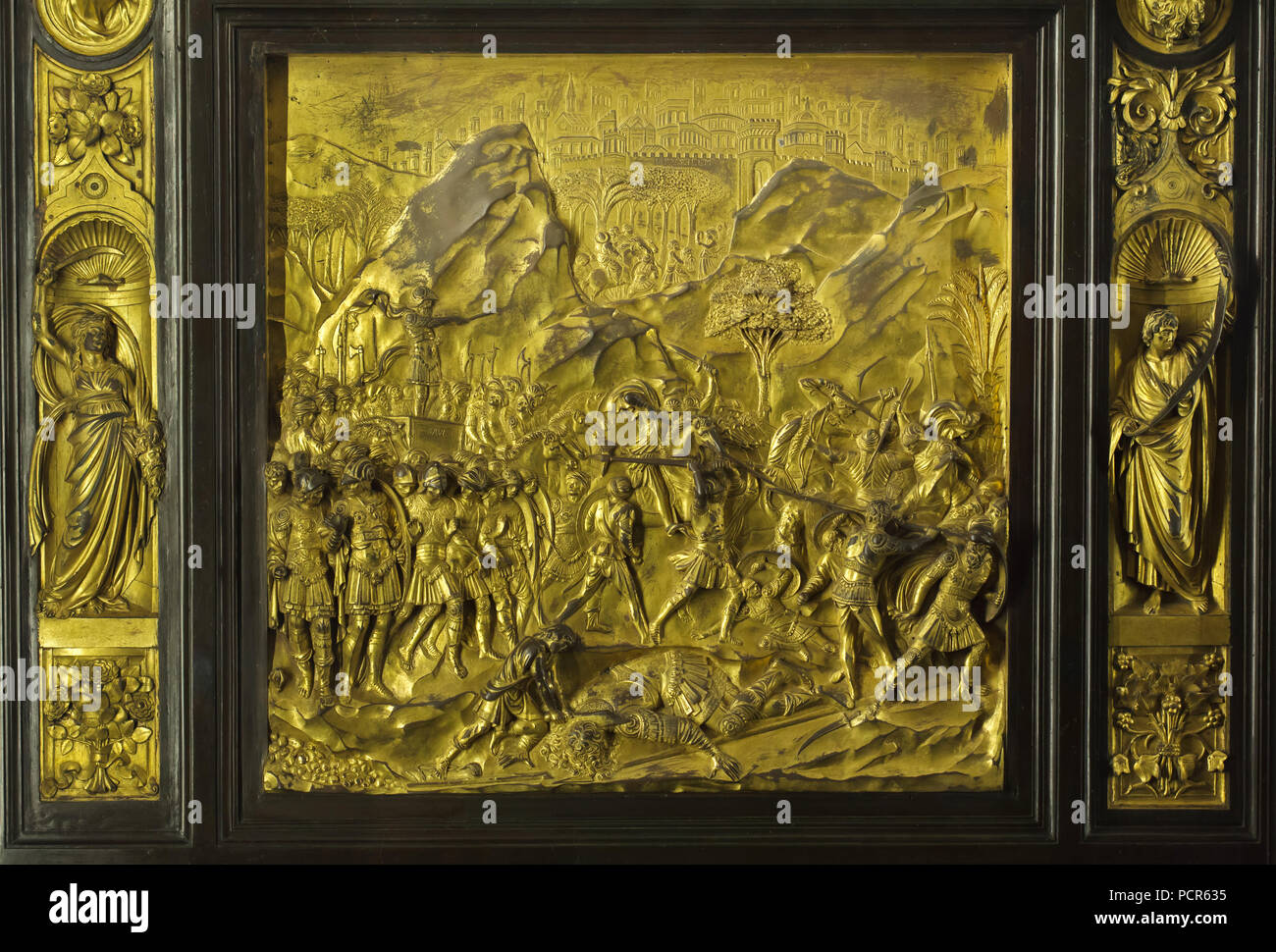 Story of David and Goliath depicted in the gilded bronze panel from the Gates of Paradise (Porta del Paradiso) designed by Italian Early Renaissance sculptor Lorenzo Ghiberti for the Florence Baptistery (Battistero di San Giovanni), now on display in the Museo dell'Opera del Duomo (Museum of the Works of the Florence Cathedral) in Florence, Tuscany, Italy. Stock Photo