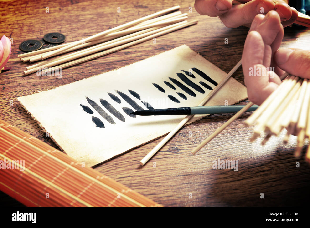 I ching ancient Chinese oracle with Yijing hexagram, old coins and stalks Stock Photo