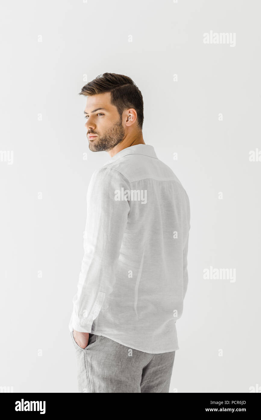 rear view of man in linen white shirt posing isolated on grey ...