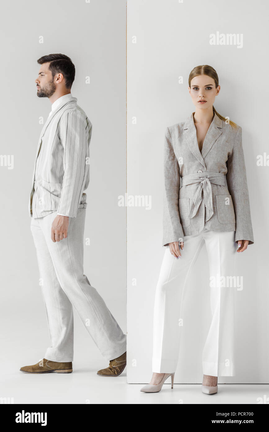 fashionable young male and female models in vintage clothes on white