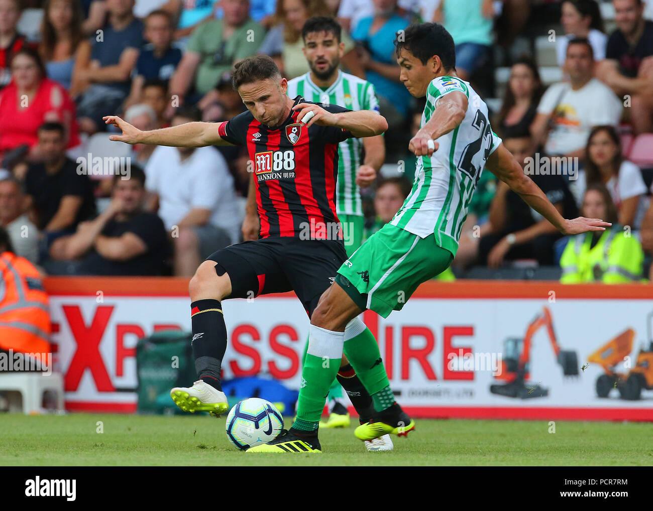 Bournemouth's Marc Pugh tackles Aissa Mandi of Real Betis during the pre-season friendly at the Vitality Stadium, Bournemouth. Stock Photo