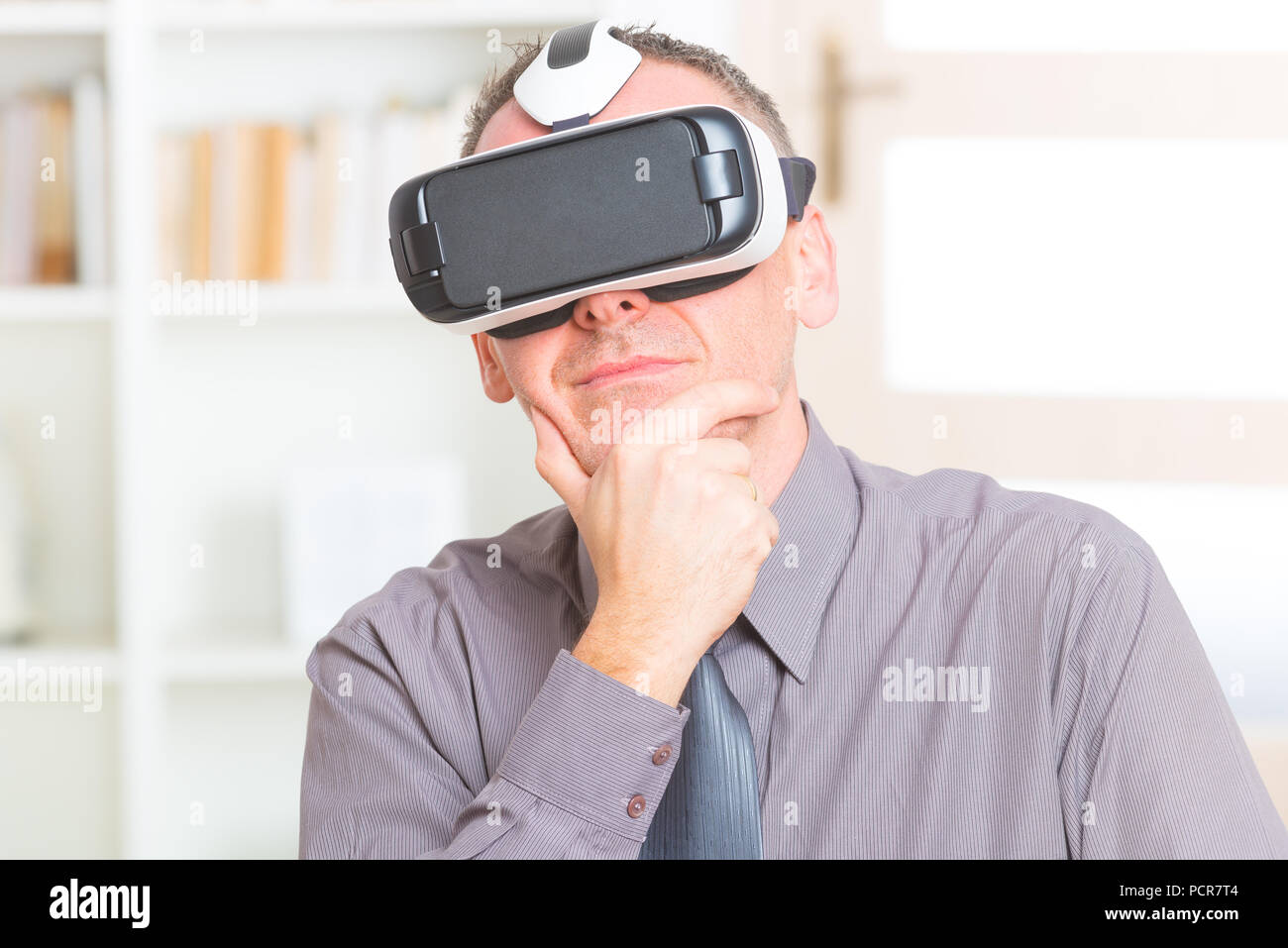 Businessman using virtual reality headset at the office Stock Photo