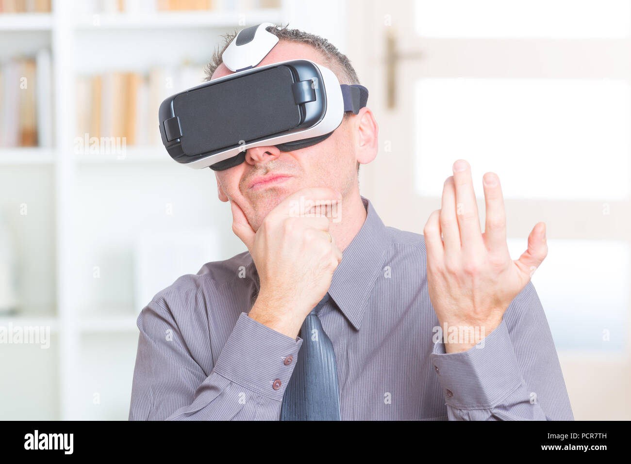 Businessman using virtual reality headset at the office Stock Photo