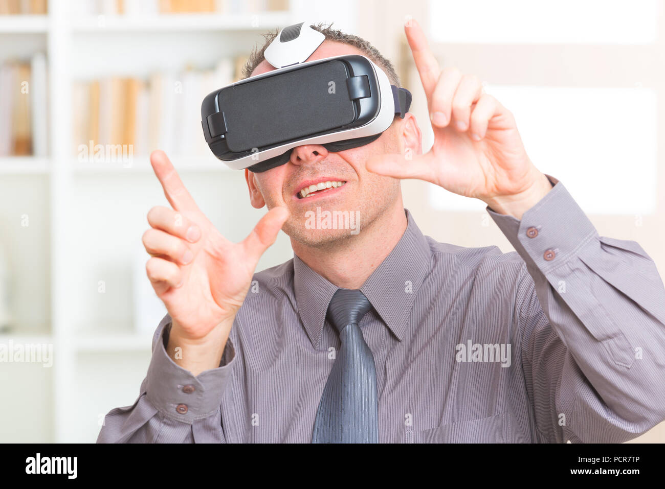 Businessman using virtual reality headset at the office Stock Photo
