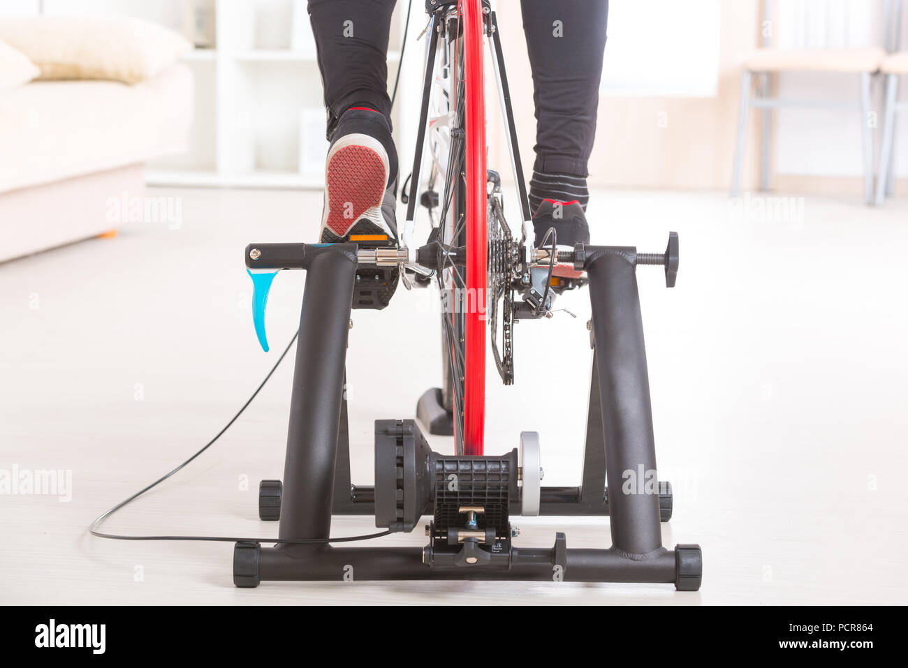 Man using cycle trainer at home Stock Photo Alamy
